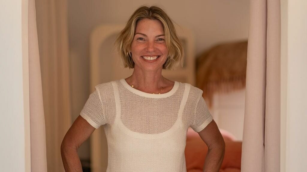 Jodie Lee smiling in the doorway of her Tweed Heads treatment room